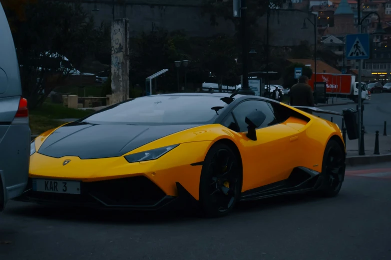 an orange sports car driving in traffic near a bus