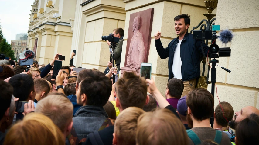 a crowd of people standing in front of a building