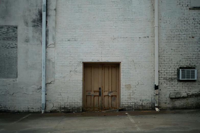 a white building with three wooden doors
