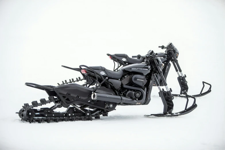 a motorbike with one front skied down in the snow