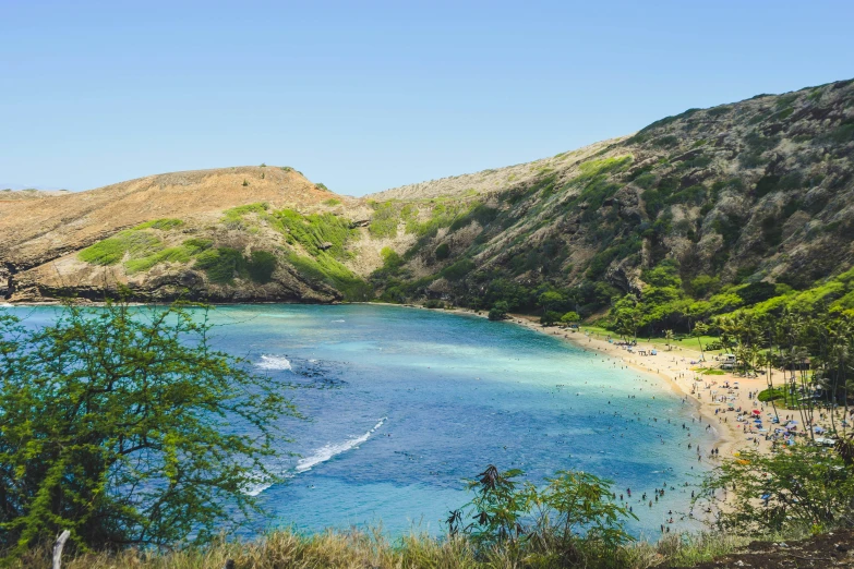 a rocky cliff is next to a lagoon in the middle of a mountain