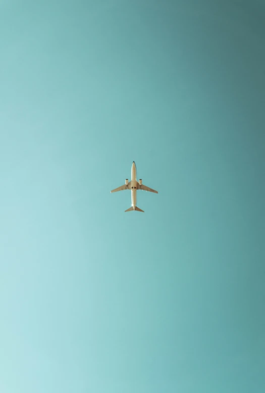 an airplane in the sky against a blue sky