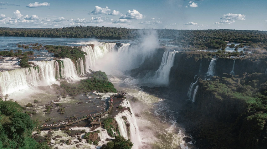 a man is standing in front of the falls