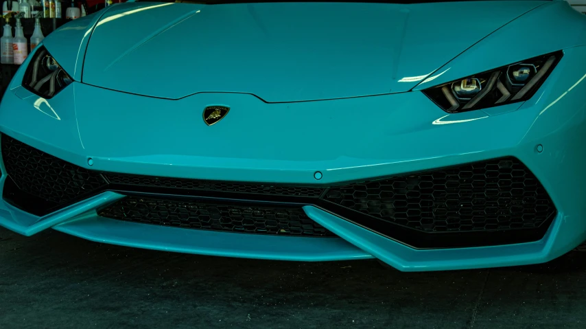 a blue sports car parked inside a room