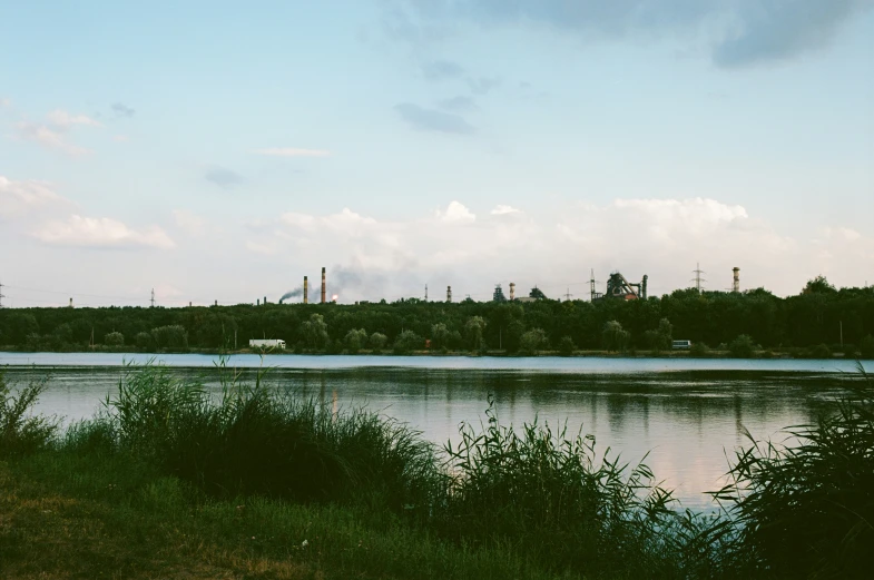 the view of a river and factory from a distance