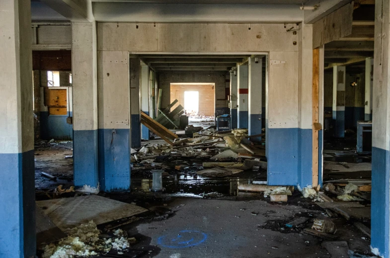 an abandoned room with some debris all over the floors and a fire hydrant
