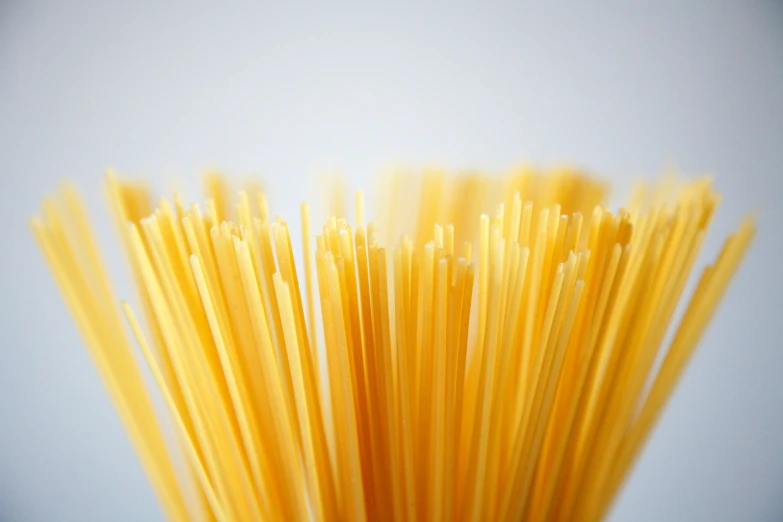 a lot of yellow spaghetti is sticking up