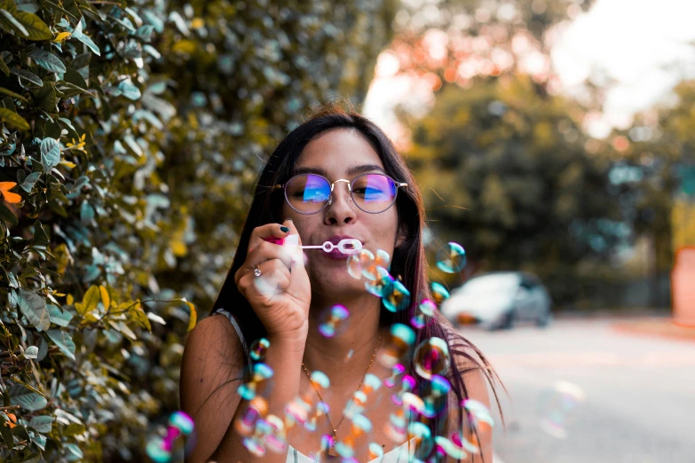 a woman blows bubbles with her tongue
