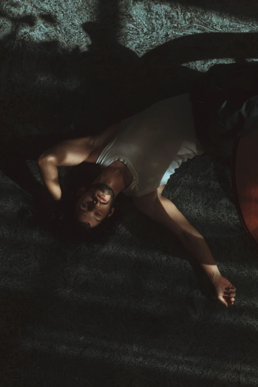 a man is lying on the floor with his hands in his pockets