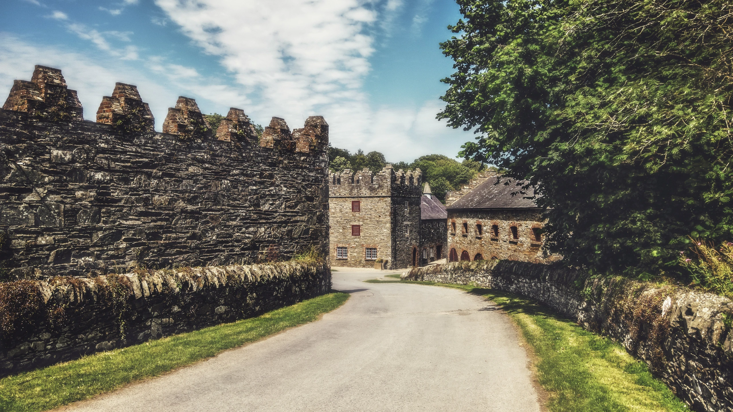 an old stone building has a stone walkway between it