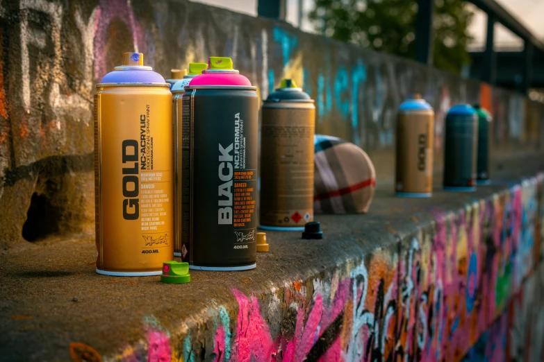 the spray cans have been placed on the concrete wall