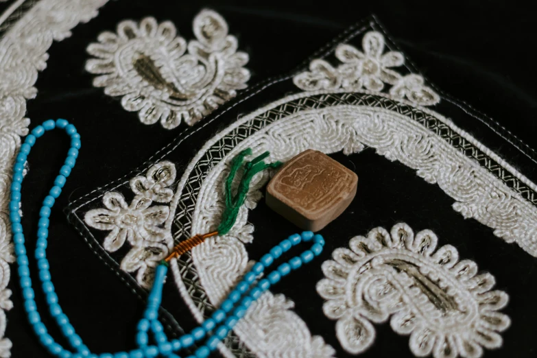 a square piece of fabric and a string laying on a table