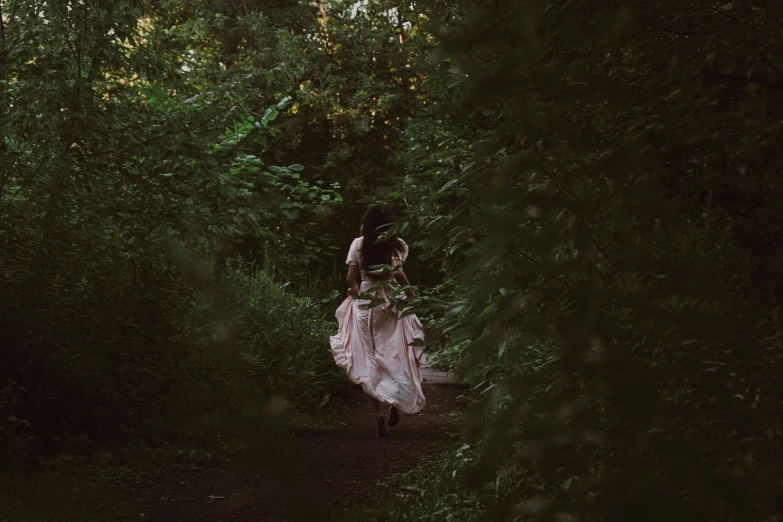 a woman on her back in a forest