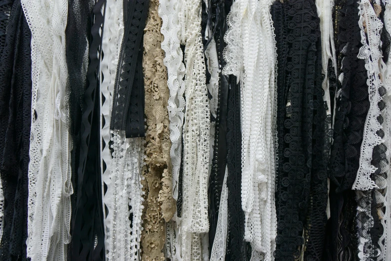 lace is on display and some black and white fabrics are dd