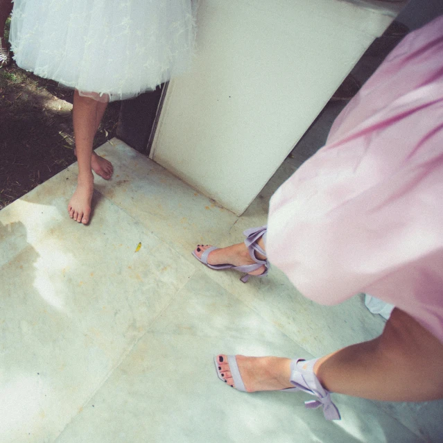 the two woman are standing outside by the door