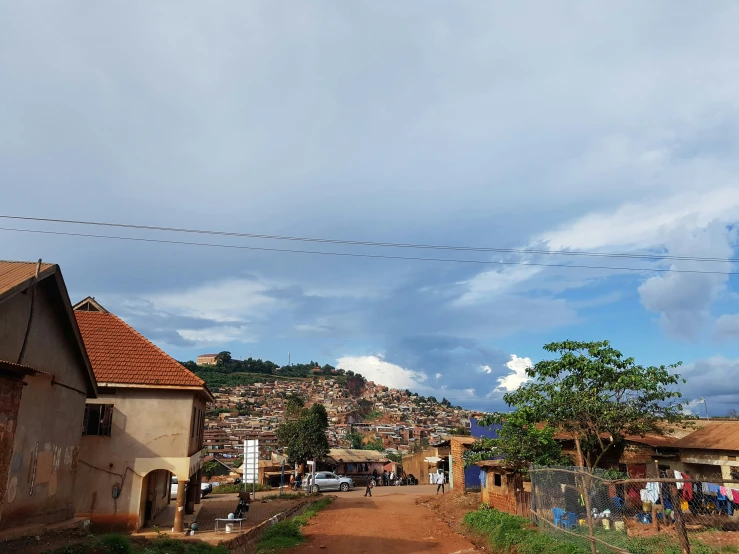 people stand near an old village in africa