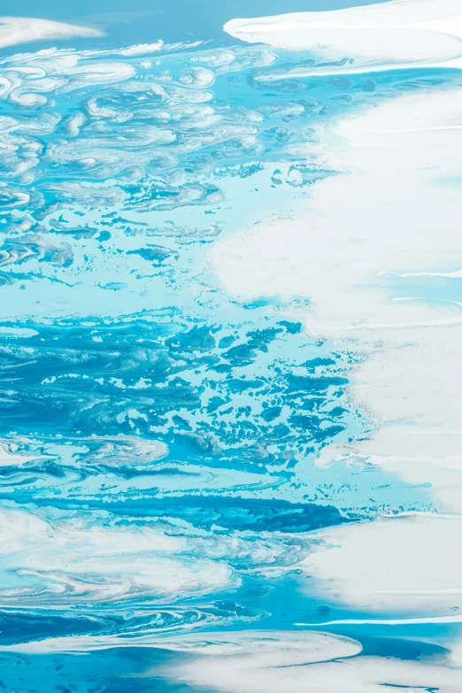 an aerial view shows bright blue water and white sand