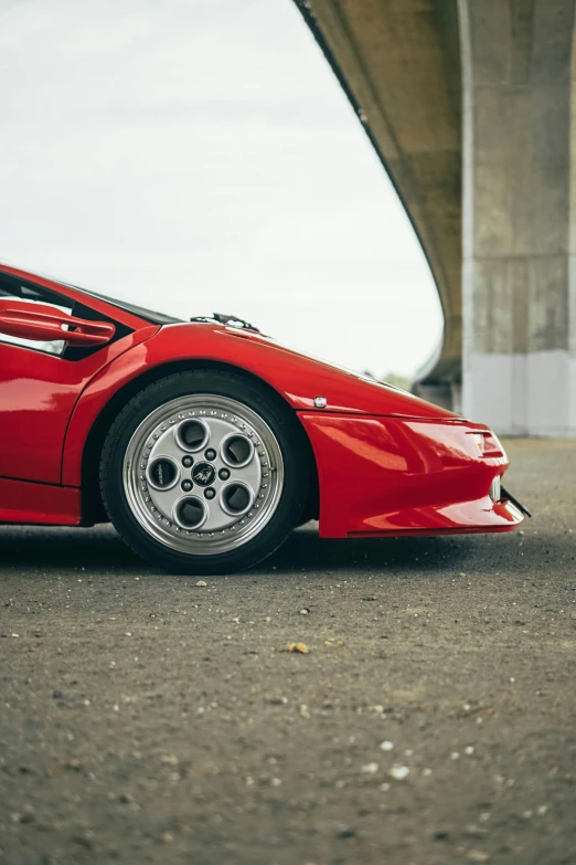 a red sports car parked under an overpass