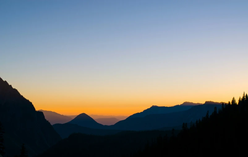 mountain with trees and a few mountain ranges