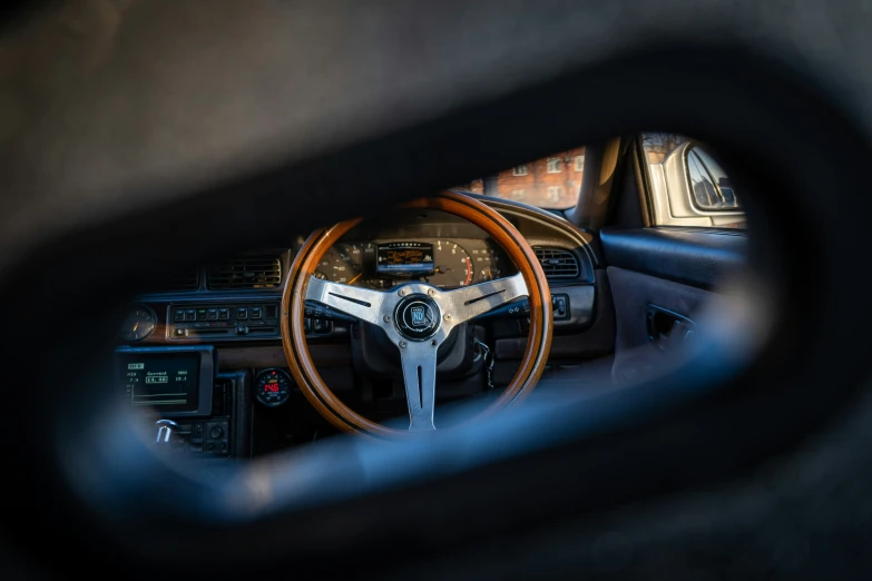 a car's interior and the dash is reflected in a mirror