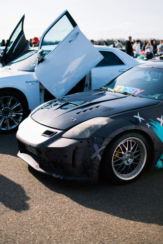 two cars one with an open hood and the other decorated in stars