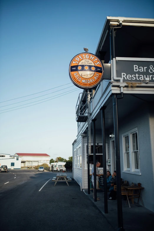 there is a sign for a bar and restaurant outside of the building