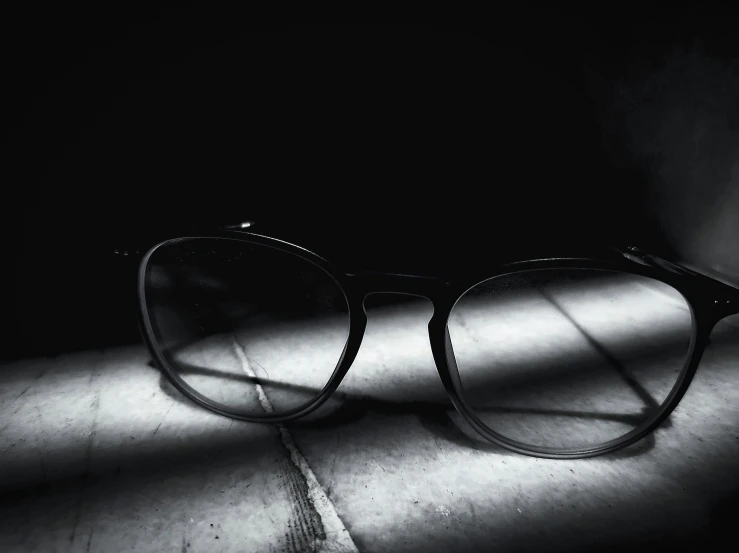 a black and white pograph of a pair of glasses