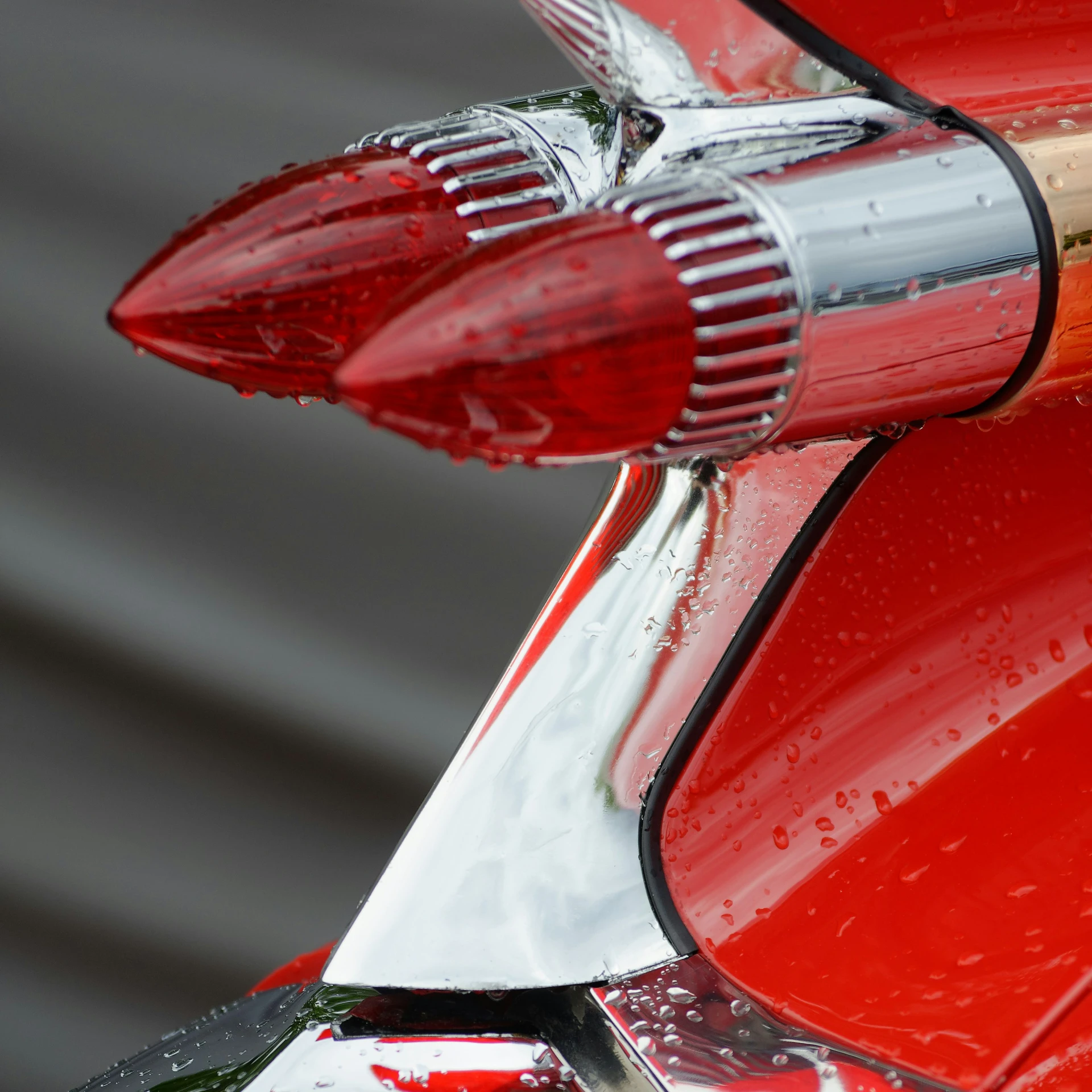 an extremely close up view of a shiny red vehicle