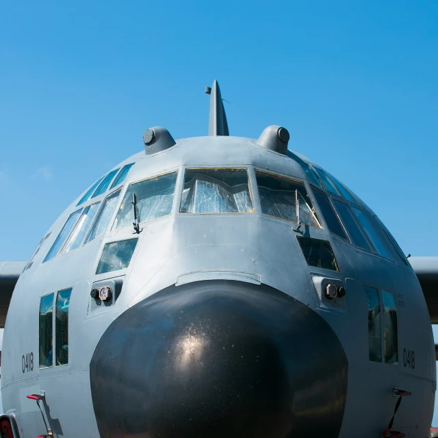 an airplane is sitting on the grass and it has people inside of the cockpit