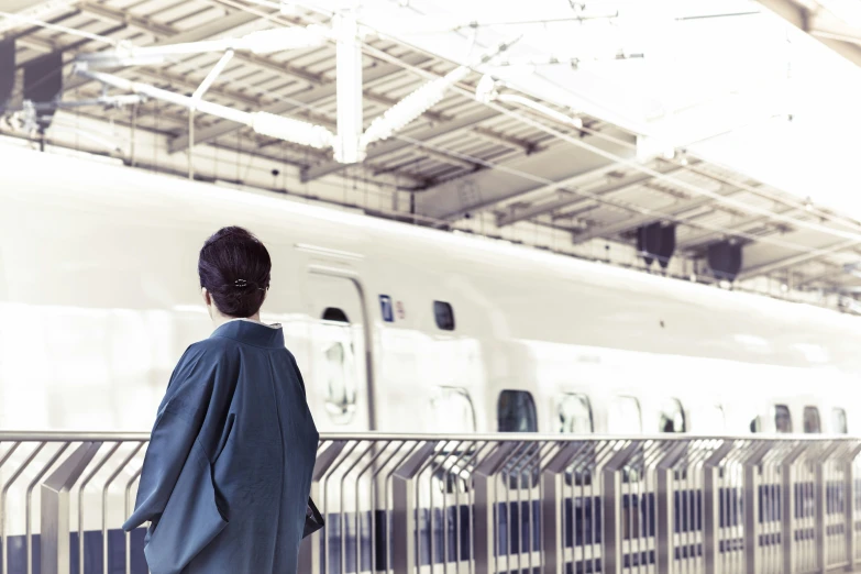 a woman standing in front of a train