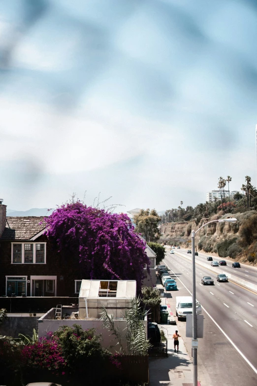 the view from a window in an apartment building looking at the street