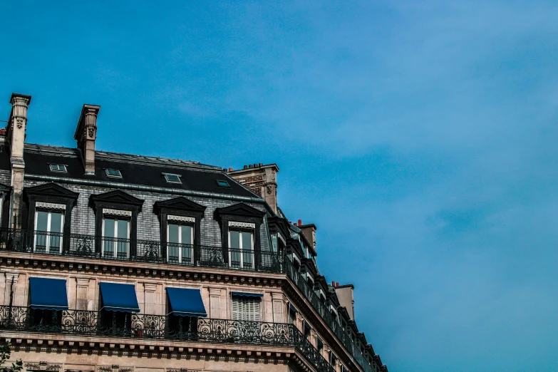 an old building is seen against a blue sky