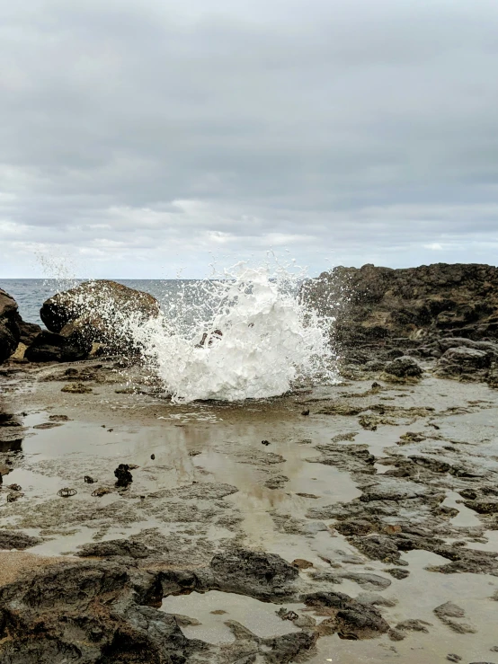 waves crashing into rocky shore near the water