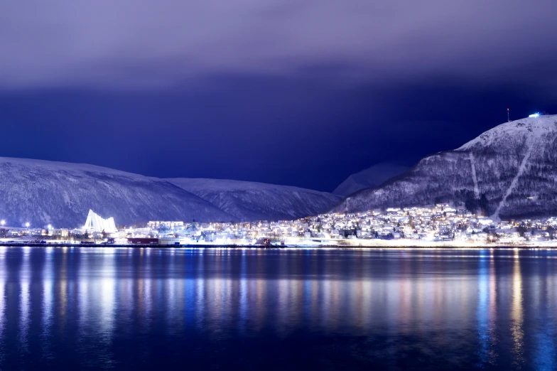 an evening view of a city lit up at night