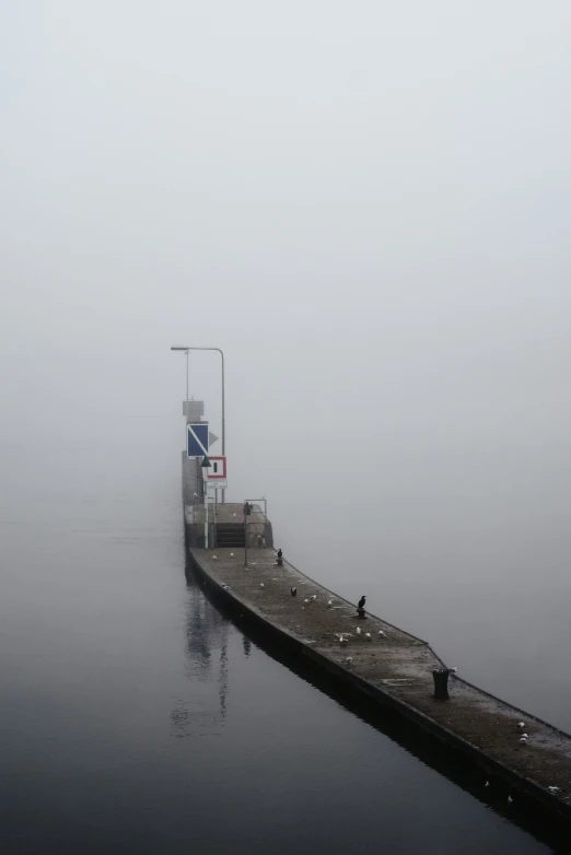 a pier on a lake with no water or people on it