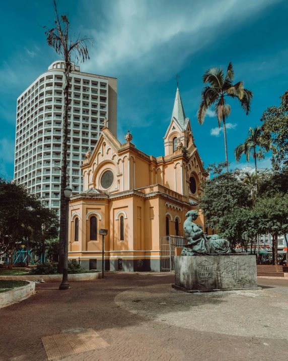 a pink church with tall buildings in the background