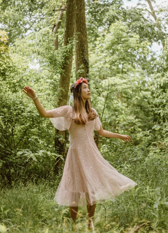  in the woods in a pink dress