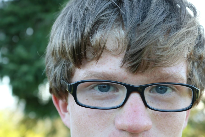  wearing glasses with hair comb in an outdoor setting