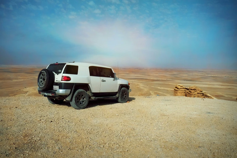 a humongous vehicle is parked on the desert