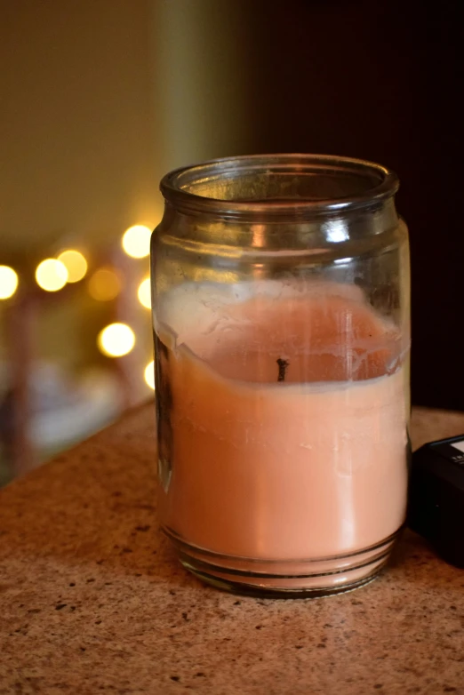 a candle and a remote sitting on a table