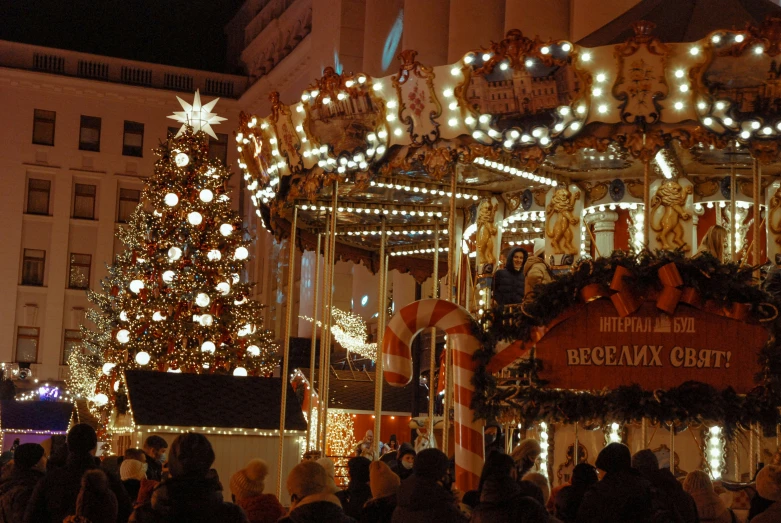 an elaborate merry - go - round merry christmas tree with lights