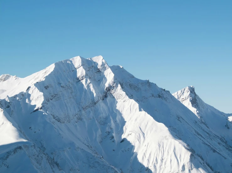 skiers at the bottom of a steep snowy mountain