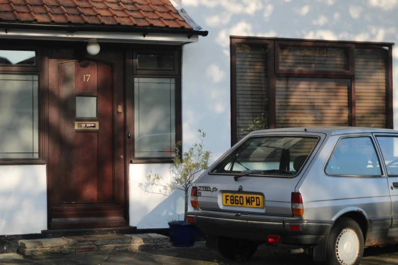 a car parked outside of a white building