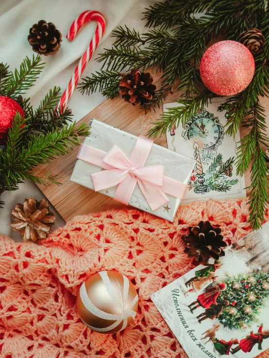 christmas tree ornaments with cards, candles and presents on a table