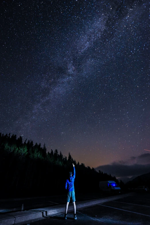 a man taking a picture with a cellphone at night