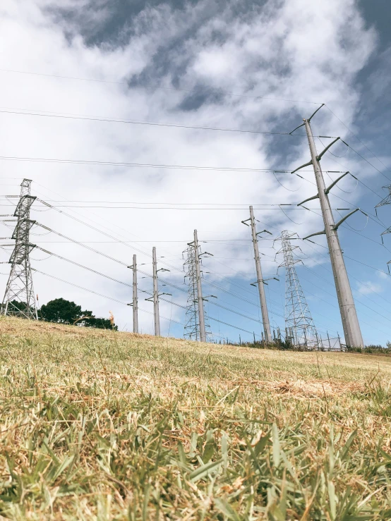 a number of telephone poles in the grass