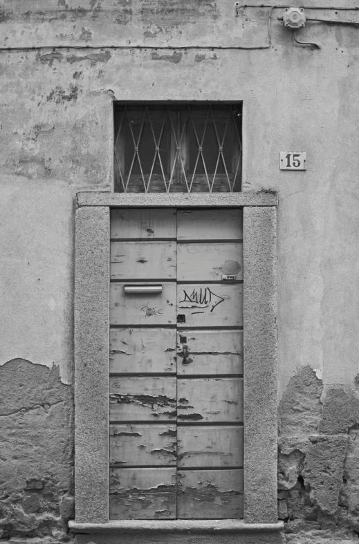 a door on the outside of a building that has graffiti on it