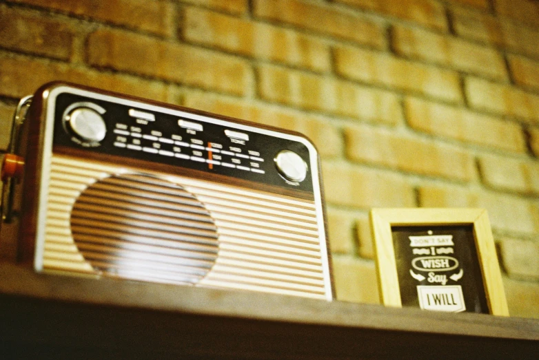 a radio is sitting on top of a wooden shelf