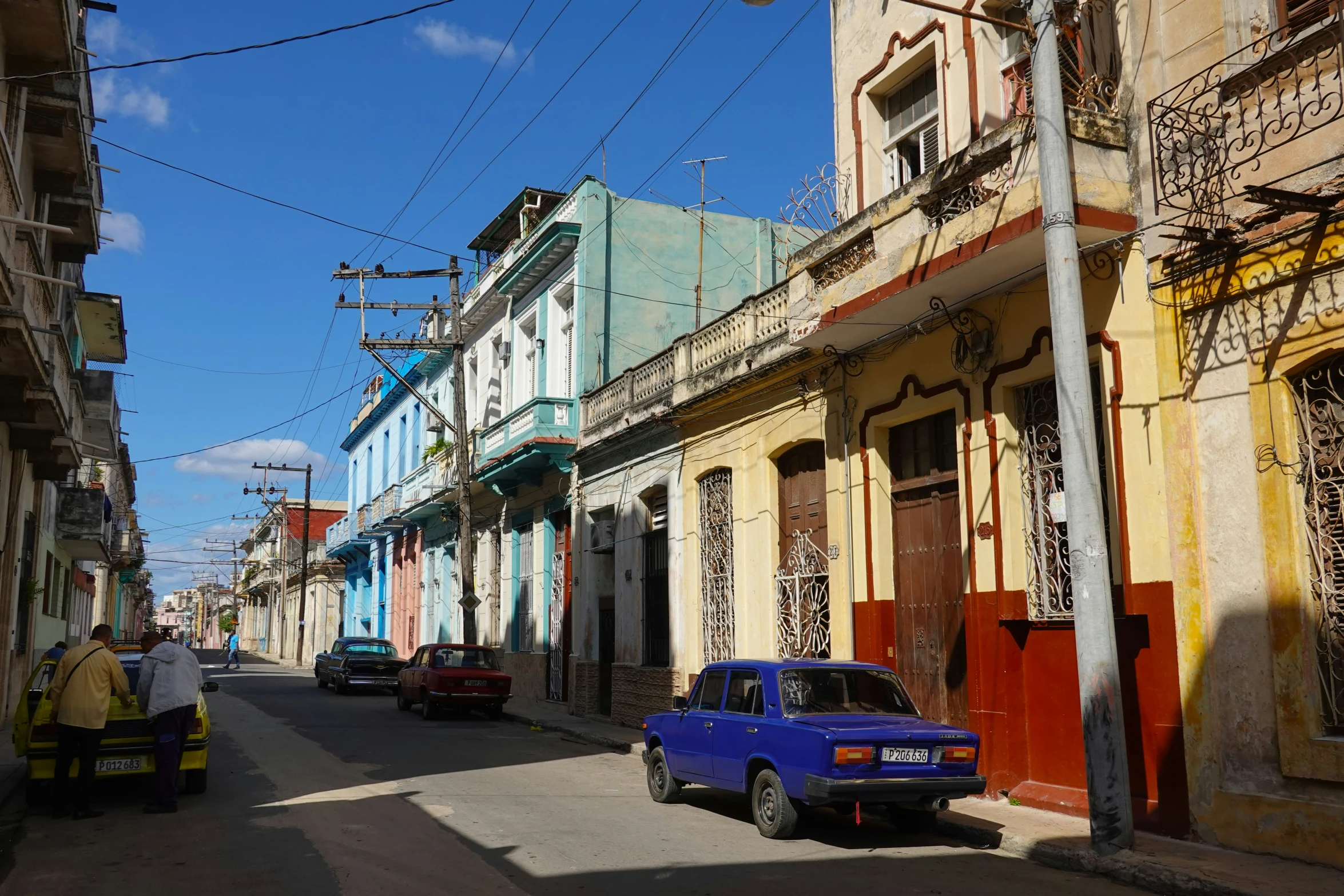 an empty street with two cars parked next to each other