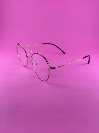 a pair of glasses sitting on top of a purple background